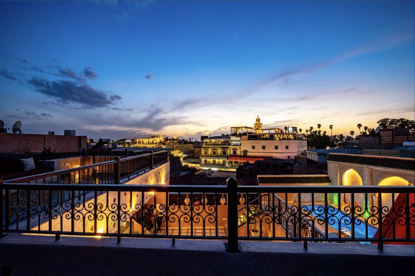 Terrasse et piscine du Riad Hamdane au crépuscule, vue sur les toits de la médina